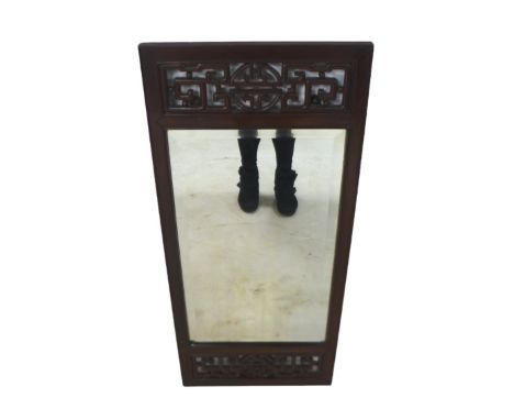 A Chinese hardwood framed wall mirror, with carved detail, 45 by 3 by 101cm high.