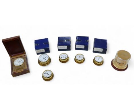 A collection of seven brass cased clocks and gauges, including seven by Wempe, featuring a wooden cased clock, 13 by 17 by 6.