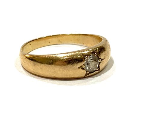 A yellow gold solitaire diamond gypsy ring, the round cut stone 3.5 by 2.5mm, 0.18 ct, in star cut setting, 5.8mm at widest, 