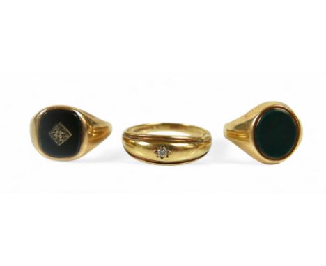 Three 9ct gold rings, comprising a large gypsy set solitaire diamond ring, stone size approximately 2mm diameter, size Z, 4.3