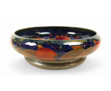 A Moorcroft Pomegranate design Tudric pewter based fruit bowl for Liberty &amp; Co, the shallow bowl of circular form, the ha