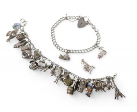 A silver charm bracelet, with multiple charms, including an Eiffel Tower, Statue of Liberty, railway lamp and cruise ship, to