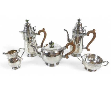 An Elizabeth II Irish silver five piece tea and coffee service, of ovoid form with engraved foliate decoration, turned jade f