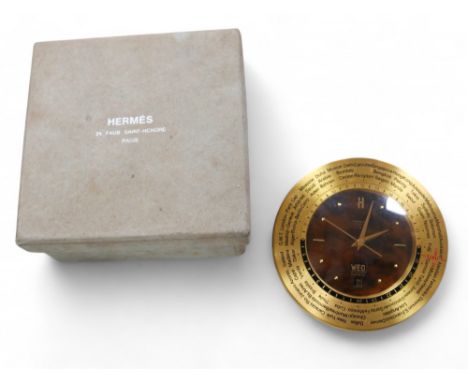 A retro Hermes world time desk clock, with tortoise shell effect dial, day and date apertures, and adjustable outer ring, 11c