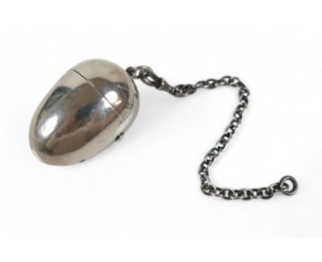 A Victorian silver egg form sewing companion, with hinged cover, ring top mount and short silver chain, the interior fitted w