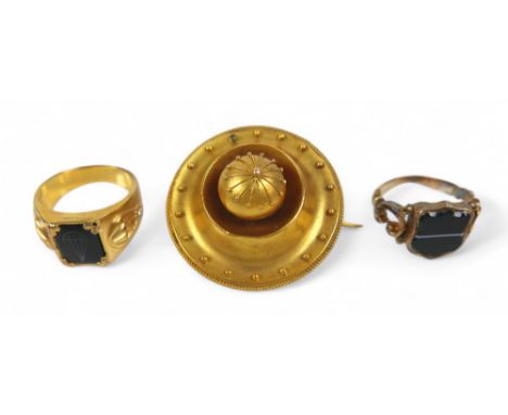 A gilt metal mourning brooch and two rings, gilt parachute ring size U, signet ring size Q, total weight 23.7g. (3)