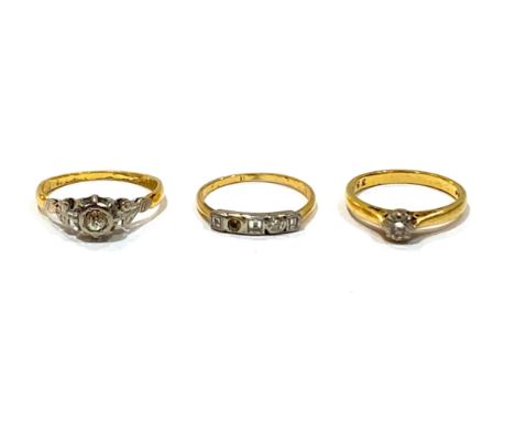 A group of three gold rings, comprising an 18ct yellow gold diamond solitaire ring, the round cut stone approximately 0.25ct,
