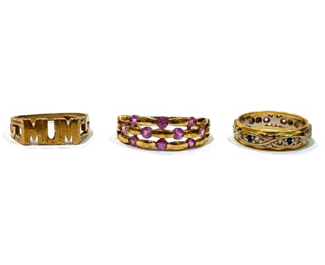 A group of three gold rings, comprising an 18ct white and yellow gold ring set with small dark blue sapphires, 4.5mm wide, si