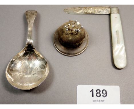 A Georgian silver caddy spoon with bright cut decoration, Birmingham 1829, a silver and mother of pearl fruit knife, Sheffiel