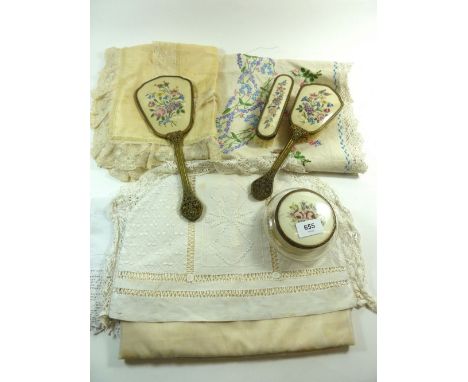 A vintage dressing table set and a small group of embroidered table cloths, silk and lace cushion cover, tea cosy etc 