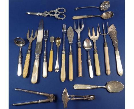 A group of silver-plated cutlery items,  includes grape scissors, cake knife, jam spoons, bread forks etc 