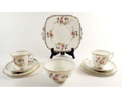 An Adderley tea service with bird and floral decoration comprising four cups and five saucers, cake plate, six tea plates and