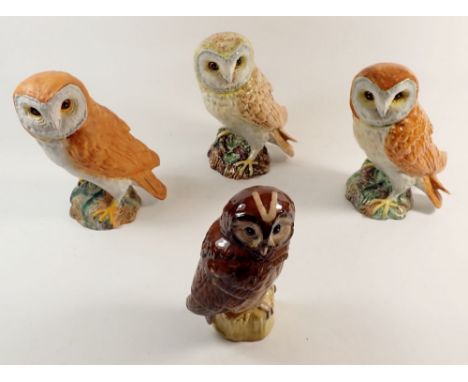 Three Beswick barn owls, one matt and the others glazed, approx 19cm high plus a Royal Doulton Tawny owl whisky flask 
