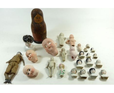 A box of dolls heads, bisque frozen Charlotte dolls etc 