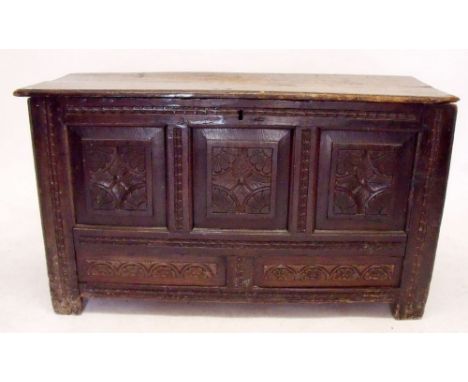 A 17th century oak coffer with triple carved panel front, 66cm high, 117cm width 