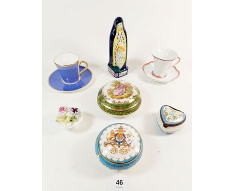 A Quimper figure of St Anne and various porcelain trinket boxes and two cabinet cups 