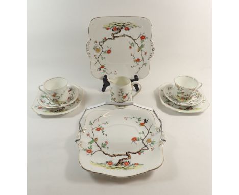 A Williamson Heathcote tea service decorated birds and branches, six cups and saucers, six tea plates, two cake plates, milk 