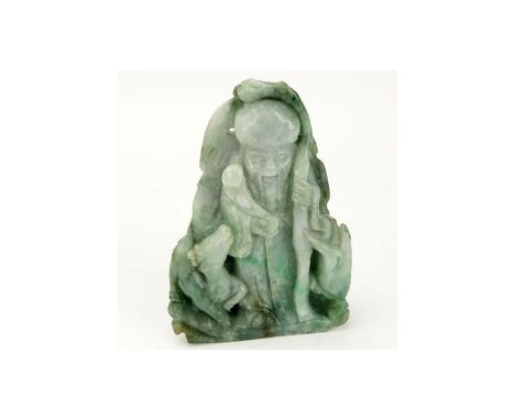 Chinese Carved Jade Shou Lao Figurine. Depicted holding staff and scepter. Light to dark green in color. Natural nicks and in