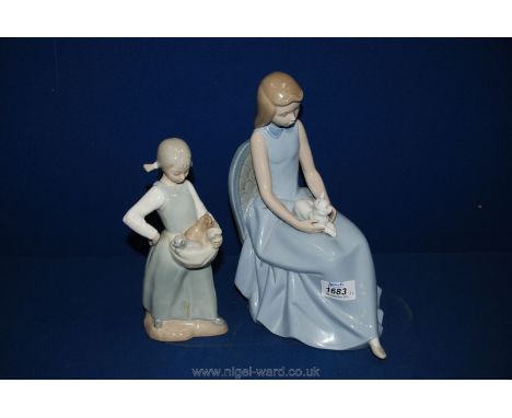 Two Nao figures: a girl with a cat on her lap and a child with pigtails and two kittens