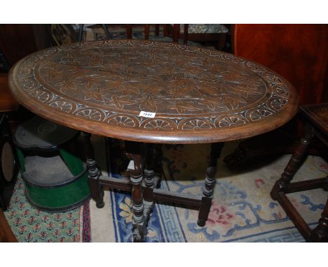 An oval foliage carved detail metamorphic Fire screen having hinged base to form an oval occasional table, the top 35'' x 23 
