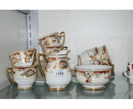 A Meito china part Teaset including six cups and saucers, tea plates, milk jug, sugar bowl and cake plate.