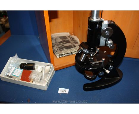 A boxed microscope no.L-201 having extra pieces, of lens etc.