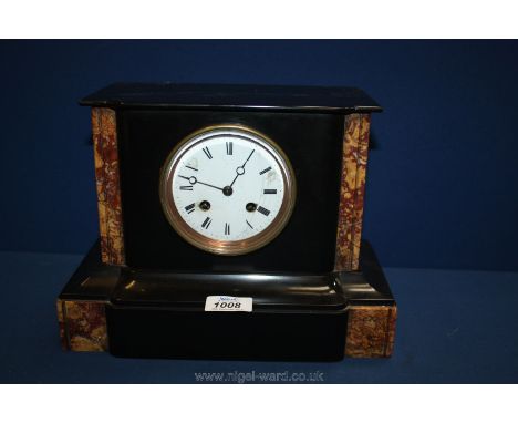 A black slate and marble mantle clock with Roman numerals.
