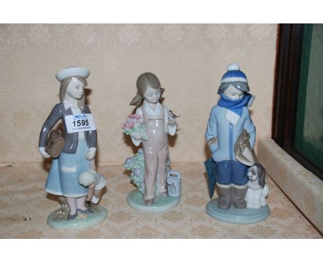 Three Lladro figures including girl holding doll and bag, girl holding flowers and bird and boy with dog.