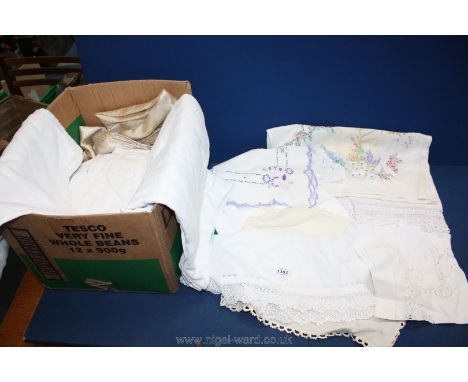 A box of linen including tablecloths and vintage lace