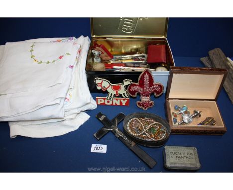 A quantity of miscellanea and linen including compass, pens, nibs, tins and contents, crucifix, drinks bar sign, Corgi Junior