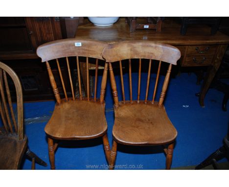 A pair of stick-back Elm seated kitchen Chairs.