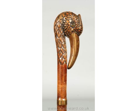 A novelty walking Stick, the handle terminating with the well-carved head of a bird, the beak being fashioned from brass, 37 