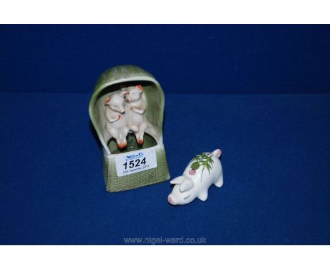 A miniature Plichta Pig with thistle design to back together with a 19th c. ceramic model of two pigs sitting in a basket wea