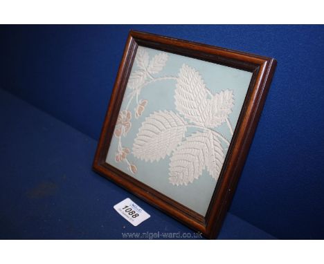 A framed tile by Maw &amp; Co. depicting leaves.