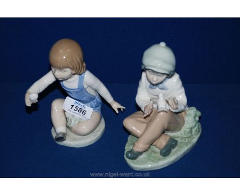 Two Nao figurines including girl with rose and boy with dove on his knee.