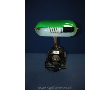 A vintage style desk lamp with green shade