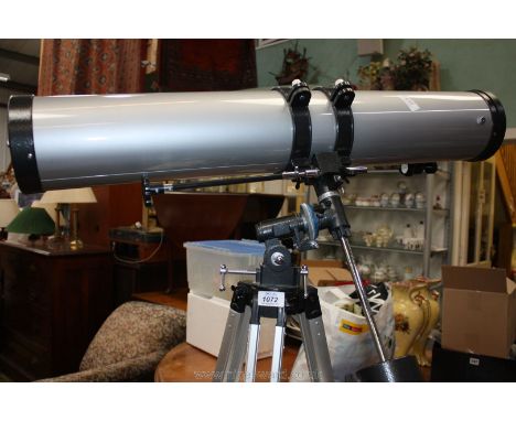 A Celestron Power Seeker 114 Telescope with manual and tripod