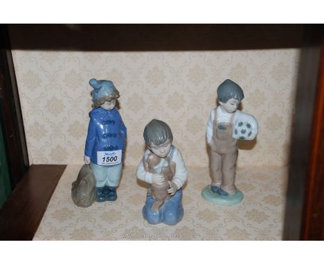 Three Nao figures of boys including, one with football, a boy with rucksack and one of a boy sitting with dog.