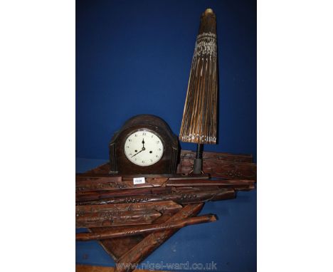 A wooden table, a/f., clock and paper parasol.