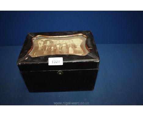 An Oriental lacquered tea caddy with photo top.