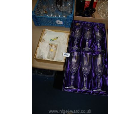 A boxed set of six Rock crystal champagne flutes, three shot glasses and two glass trays with car design
