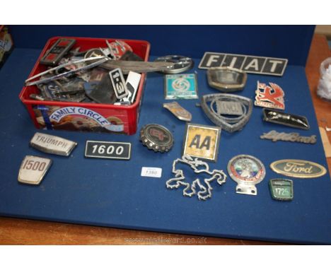 A quantity of car and lorry badges including Triumph, Vauxhall, Fiat, AA badge, etc.