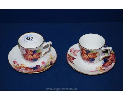 A pair of Royal Worcester Kitty Blake connoisseur collection coffee Cups and saucers in 'brambles' pattern.