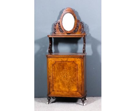 A Victorian figured walnut side or music cabinet, the whole inlaid with stringings and arabesques,with oval mirror to back an