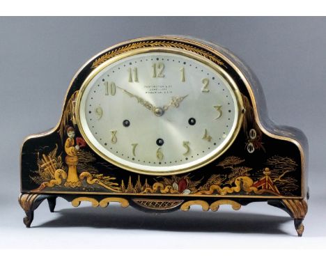 A 1920's black japanned and gilt decorated mantel clock, retailed by Partington & Co of Woolwich, the 8.25ins x 6.25ins oval 