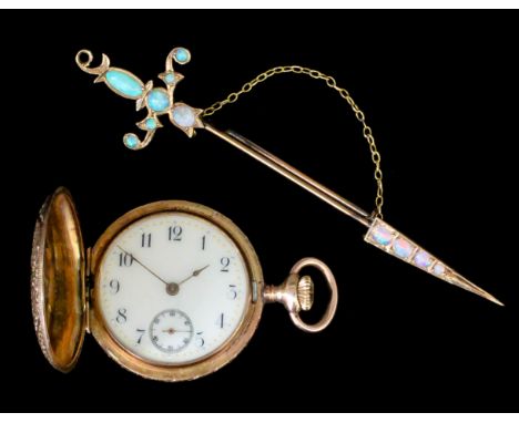 A late Victorian gold coloured metal and white opal set sword pattern brooch, set with eleven opals, 3.5ins overall, and with