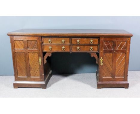 A late Victorian oak sideboard in the "Gothic" manner, with moulded square edge to top, fitted four short drawers to centre, 
