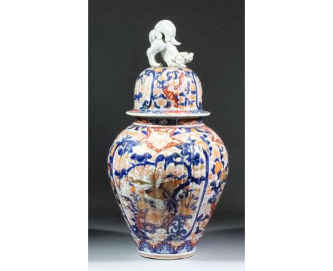 A Japanese porcelain "Imari" pattern baluster shaped vase with domed cover, reeded moulded body, with kylin finial, decorated