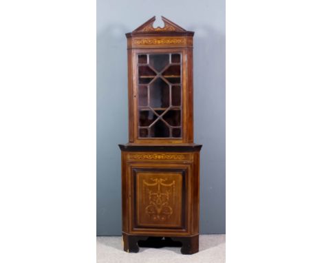 An Edwardian mahogany two tier corner cupboard of "Georgian" design, inlaid with stringings, bandings and leaf scroll ornamen