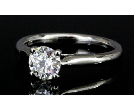 A modern platinum mounted solitaire diamond ring, set with a brilliant cut diamond of approximately .72ct (colour given as H 